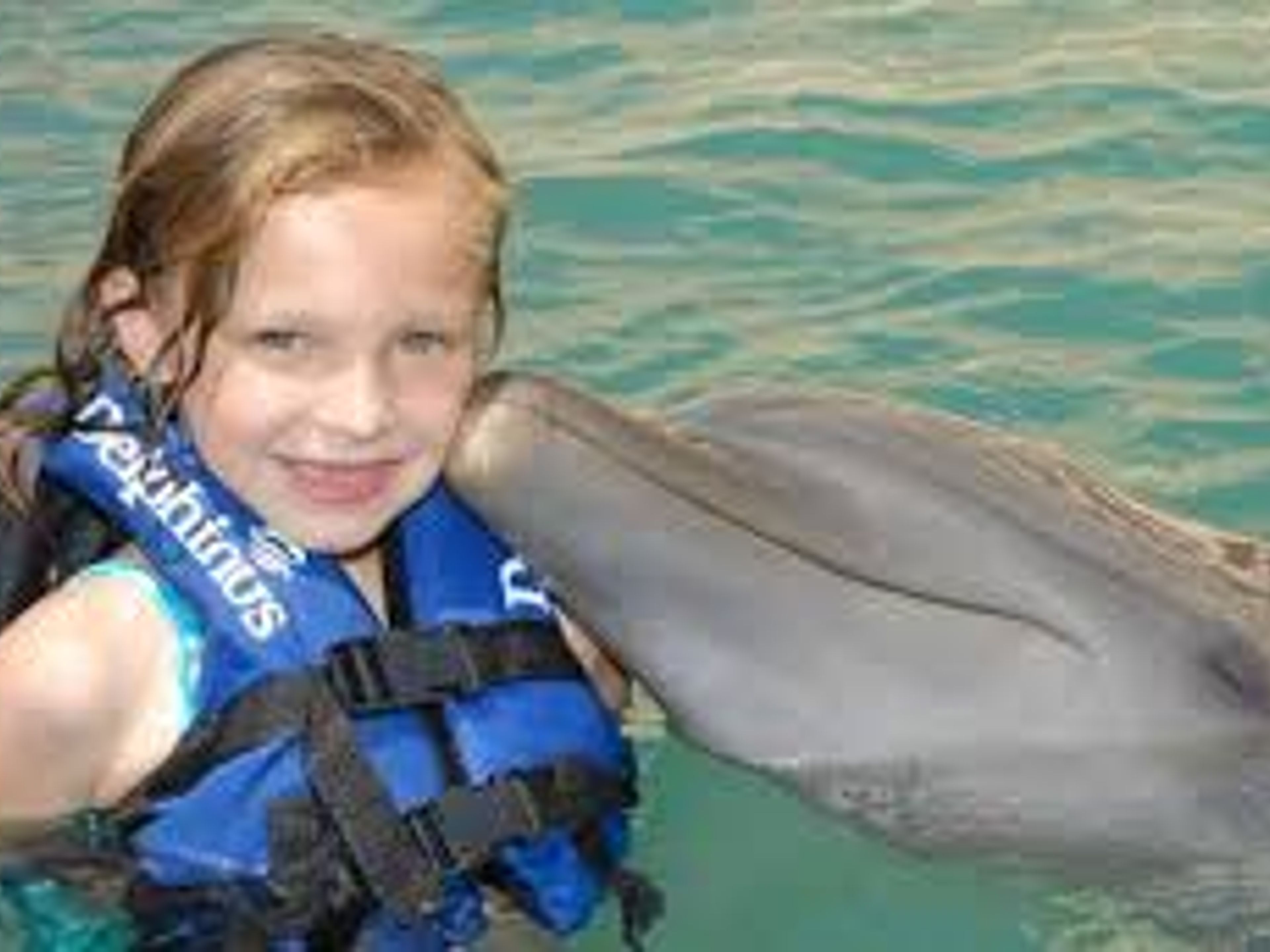 Tour "Sea Trek à Xel Ha". Kiss a dolphin in the Dolphin experience,  Xel-Ha Park. Yucatan Peninsula, Cancun. Mexico