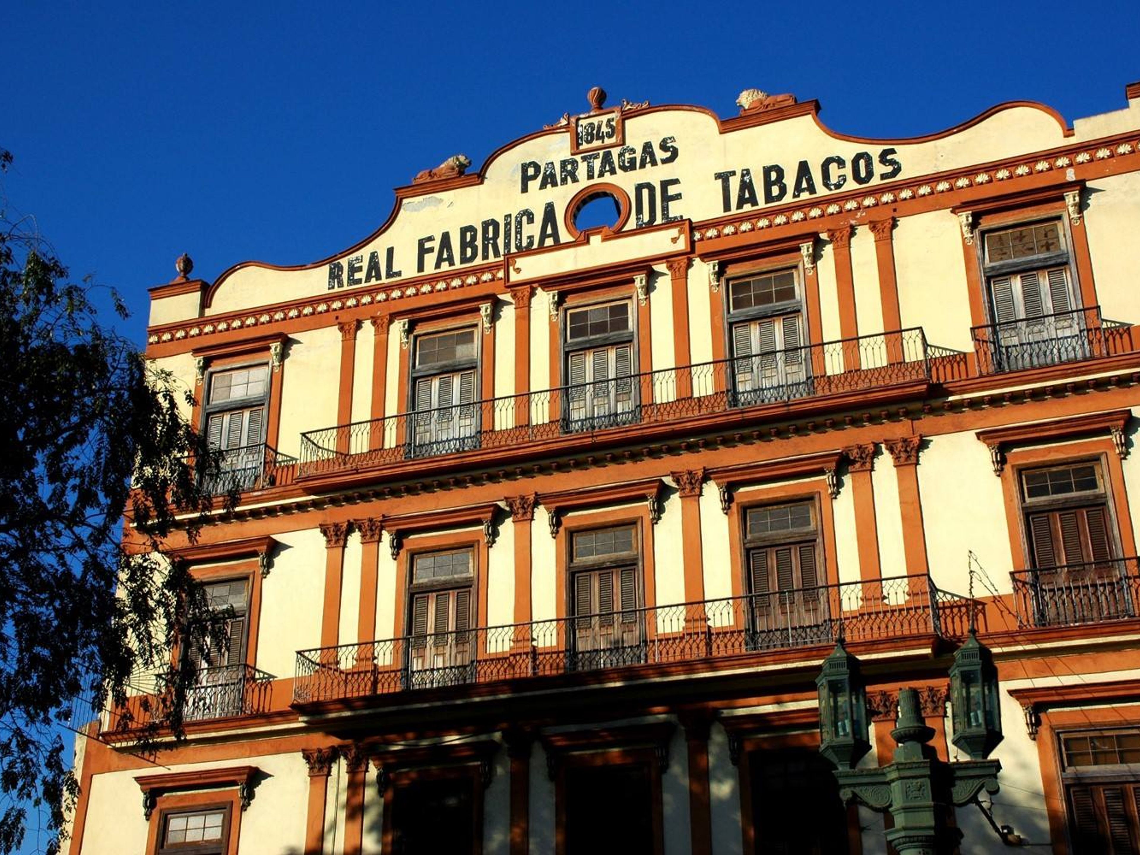 "HAVANA, HISTORY AND FUN + VISIT TO BUENA VISTA SOCIAL CLUB SHOW + DINNER IN AMERICAN CLASSIC CARS" Tour (OPTION 4). The Partagas tobacco factory panoramic view, Old Havana, Havana, Cuba.