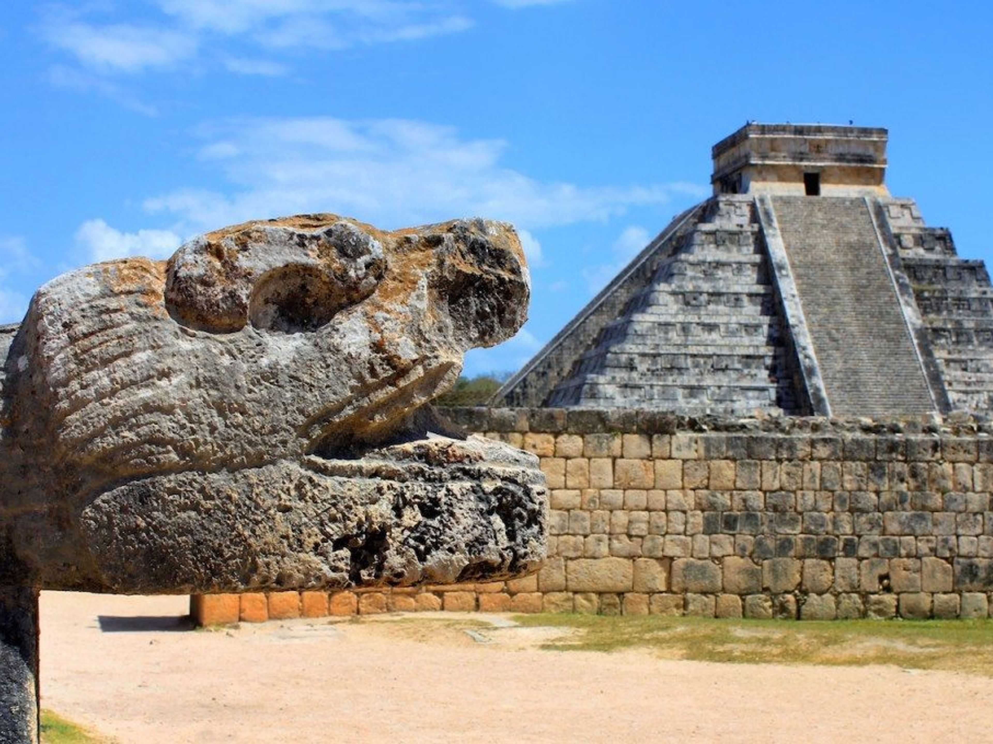 "Chichen Adventure Exclusieve VIP" Tour. A feathered serpent sculpture at the base of one of the stairways of El Castillo, in Chichen Itza Archaeological Zone, cancun. Mexico.
